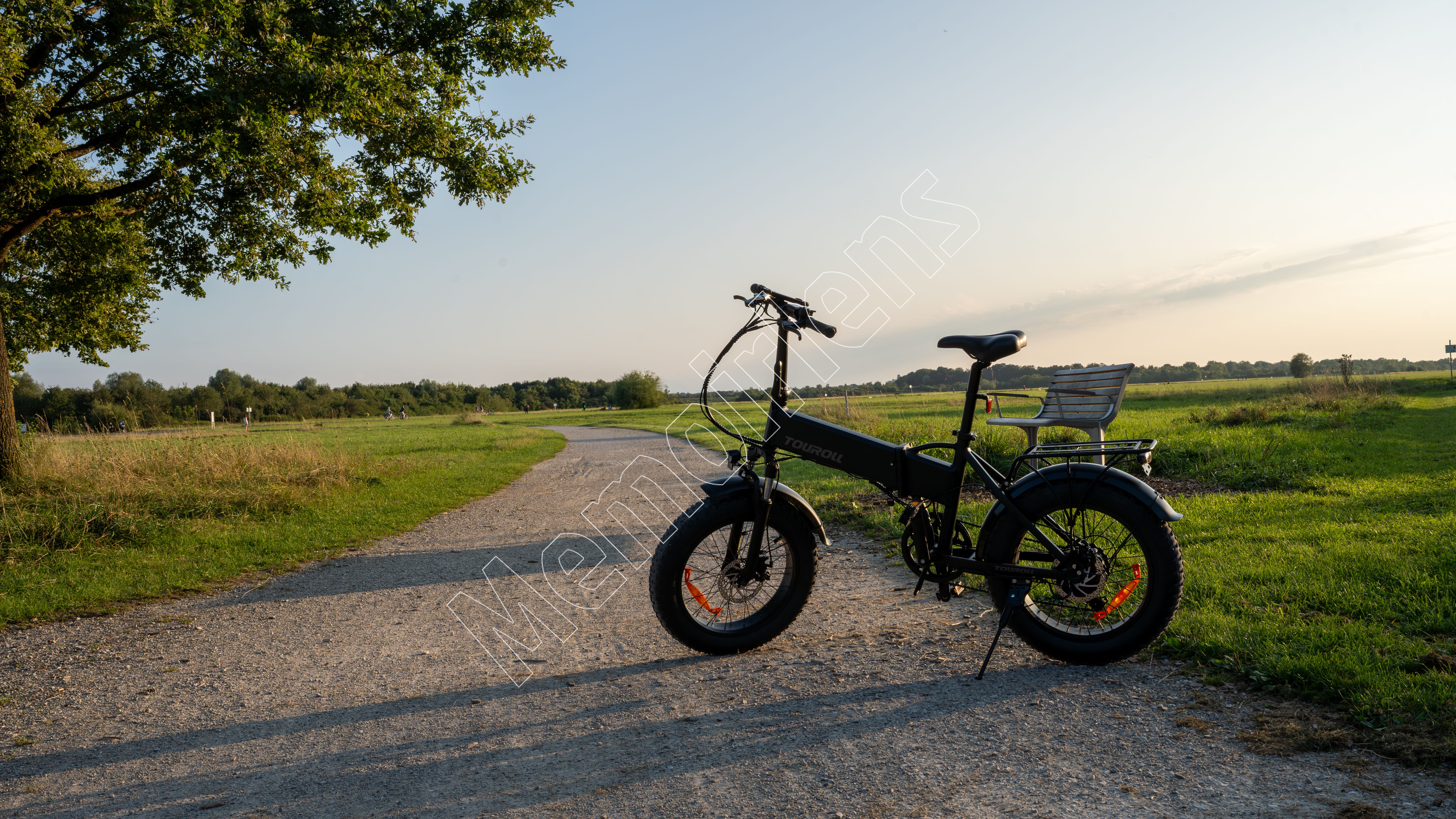 Black folding bike on path