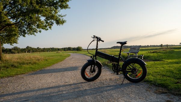 Black folding bike on path