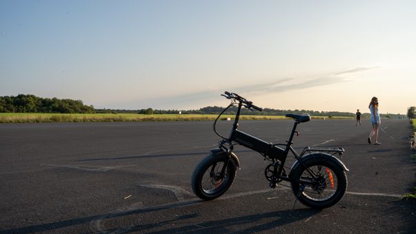 Black e-bike on open asphalt