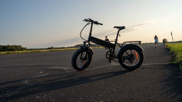 Black e-bike on open asphalt