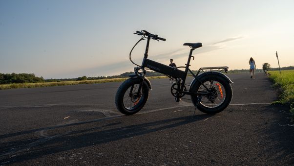 Black e-bike on open asphalt