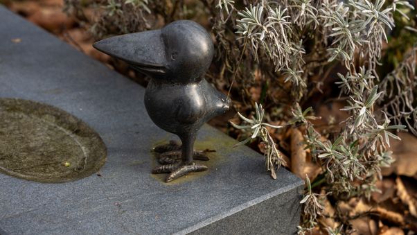 Small bird statue on stone