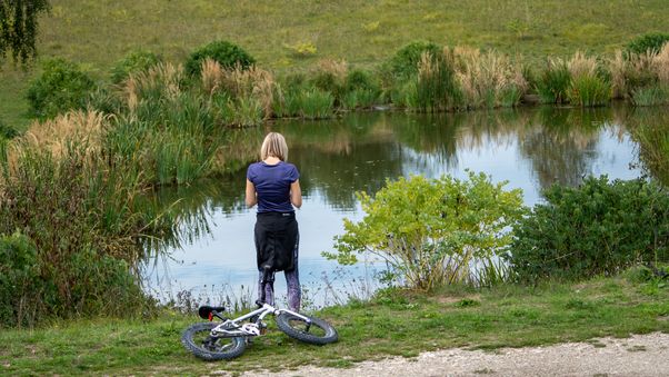 Standing by the edge of a pond